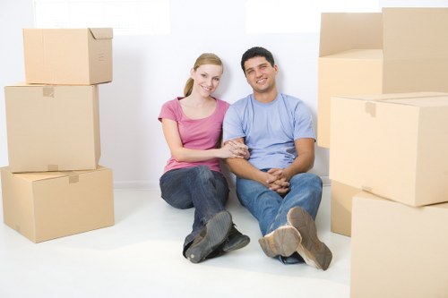 A mover carrying items from a Kennington flat with careful access planning