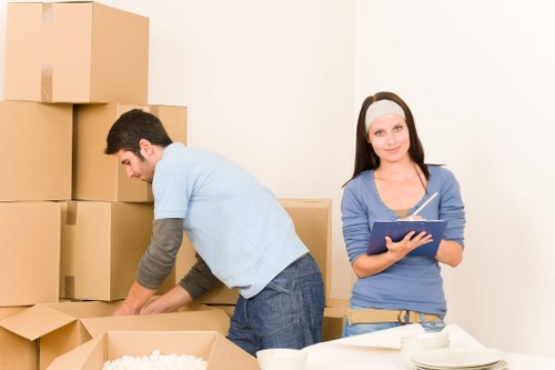 Packed moving boxes and furniture ready for transport in Kennington